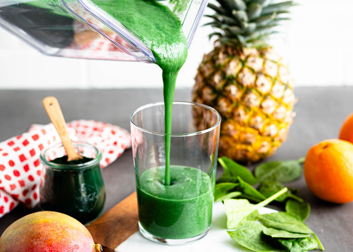 Spirulina smoothie being poured into a glass